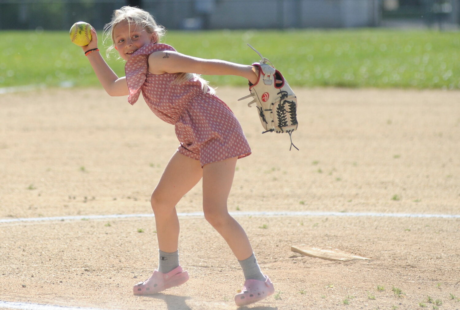 Lady Bulldogs softball team co-manager, 10-year-old Kenzie Knapp, is a fourth-grader at the elementary school. She is pictured helping her team warm up before the game against S.S. Seward. She plays travel ball, and at school during games wears jersey #75...